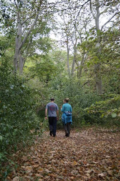 Liz Cramp walking and talking with a patient in a forest